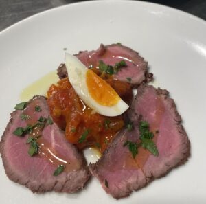 Smoked lean beef with Basque-style piperade and soft-boiled egg 