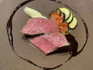 Lean Kumamoto Akaushi - roasted and plated with seasonal vegetables and sauce